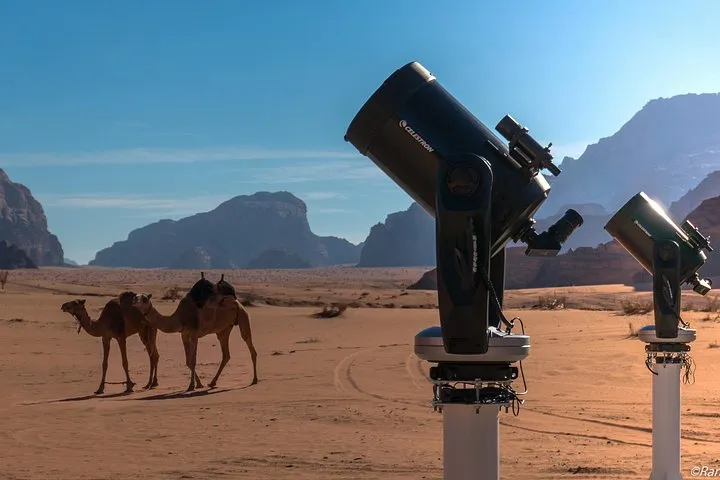 The Milky Way above the rocks of the desert on a Wadi Rum stargazing tour
