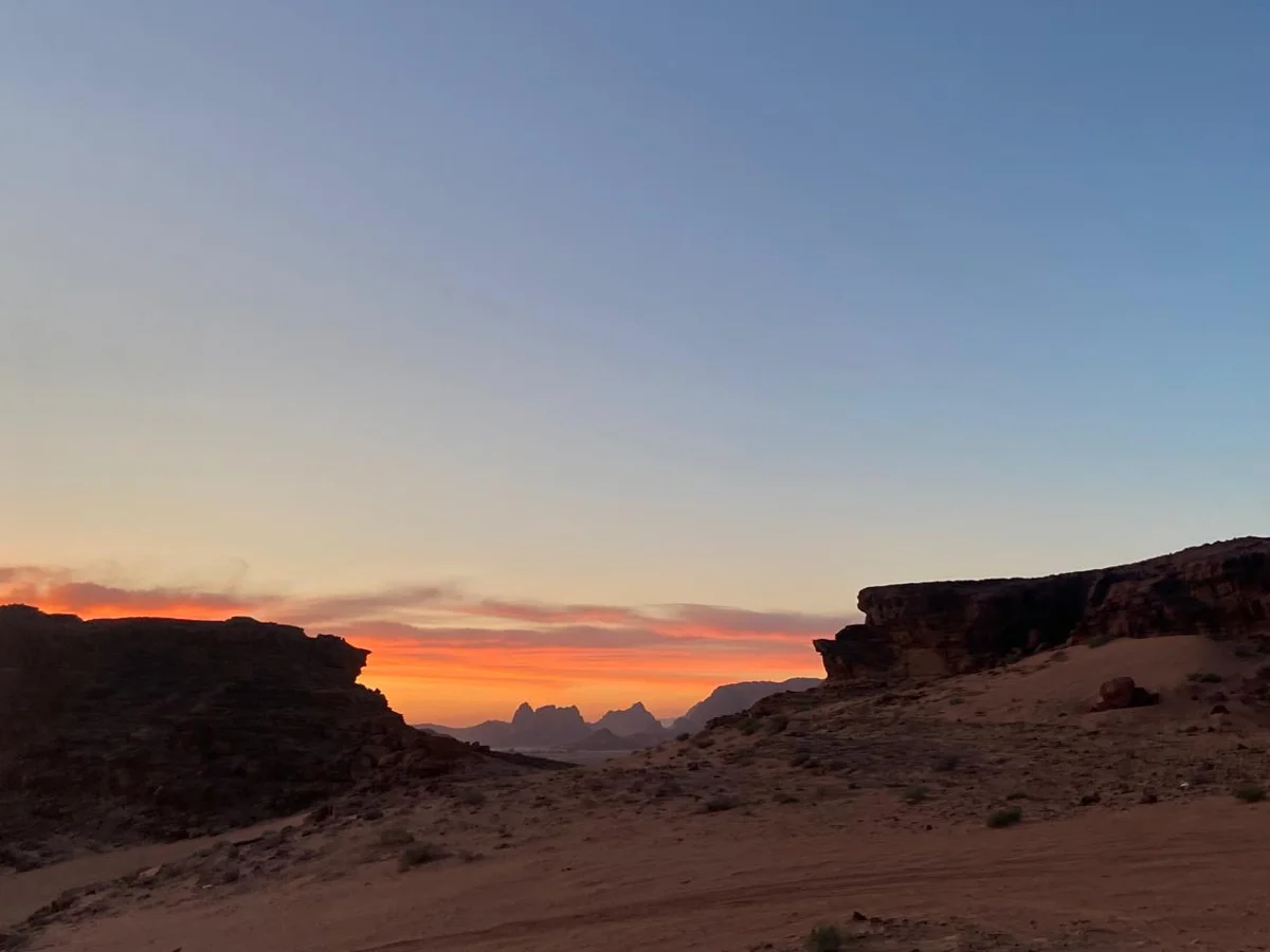 Last light over the ridges before a Wadi Rum stargazing tour